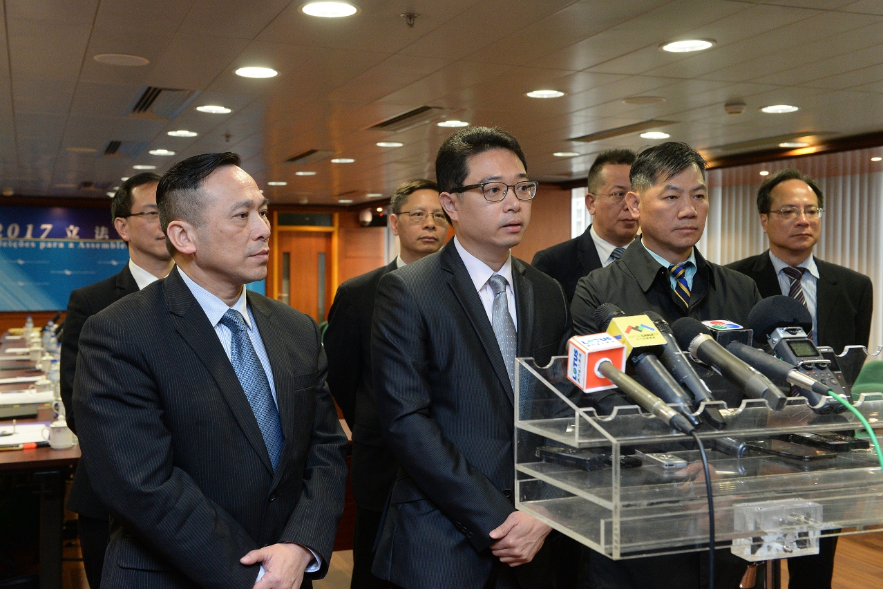 The Chairman of the Electoral Affairs Commission for the Legislative Assembly Election, Mr Tong Hio Fong (centre), meets the press after a meeting with the Judiciary Police and the Public Security Police Force.