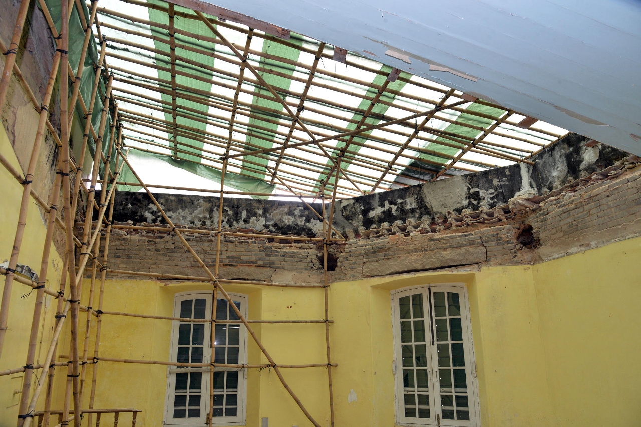 Interior view of St Augustine’s Church, showing the partial collapse of a wooden ceiling.