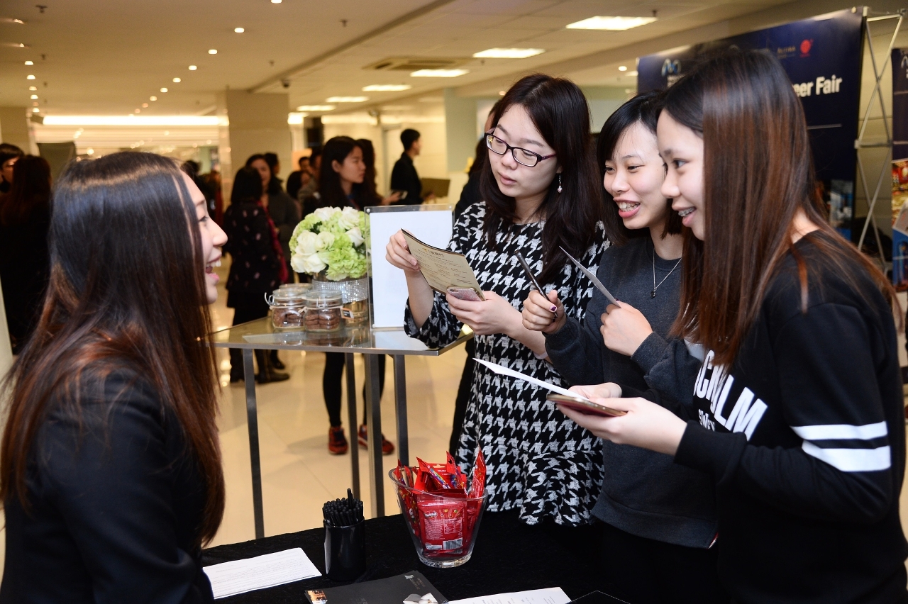 Students enthusiastically enquiring about job opportunities.
