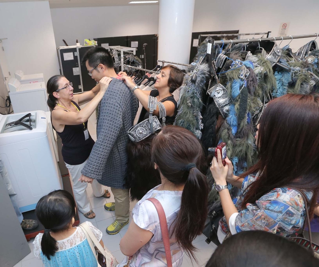 市民於歌劇《諾爾瑪》後台探索活動中，由製作團體協助親身試穿戲服，體驗歌劇演員的感覺。