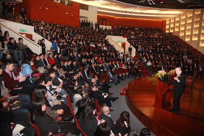 The seminar attracts a full-house audience. Even the aisles are bursting with people.